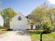 Charming two-story home featuring an attached two-car garage, a well-manicured lawn, and lovely mature trees at 2906 Crescent Knoll Dr, Matthews, NC 28105