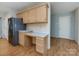 Bright kitchen with wood cabinets and stainless steel refrigerator, with a desk and an open doorway at 2906 Crescent Knoll Dr, Matthews, NC 28105
