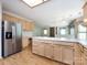 Open kitchen with light cabinets, stainless steel refrigerator, and spacious countertops at 2906 Crescent Knoll Dr, Matthews, NC 28105