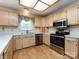Bright kitchen features stainless steel appliances, light wood cabinets and countertops, with wood-look flooring at 2906 Crescent Knoll Dr, Matthews, NC 28105