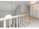Carpeted staircase with light-colored wooden railing, adjacent to a two-story foyer, and closet at 2906 Crescent Knoll Dr, Matthews, NC 28105