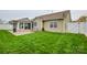 Inviting backyard with green lawn, patio, and sunroom, ideal for outdoor living and relaxation at 2981 Deep Cove Nw Dr, Concord, NC 28027