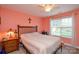 Bedroom features neutral color scheme, ceiling fan, and bright window at 2981 Deep Cove Nw Dr, Concord, NC 28027