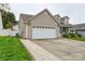 Attached two-car garage, driveway, and lawn offering convenience and curb appeal at 2981 Deep Cove Nw Dr, Concord, NC 28027