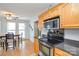 Bright kitchen with stainless steel oven, wooden cabinets and a sunny dining area at 2981 Deep Cove Nw Dr, Concord, NC 28027