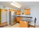 Well-lit kitchen with stainless steel appliances, tile floor, and breakfast bar at 2981 Deep Cove Nw Dr, Concord, NC 28027