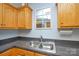 This kitchen sink features modern faucet fixtures and oak cabinets at 2981 Deep Cove Nw Dr, Concord, NC 28027