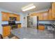 Traditional kitchen featuring stainless steel appliances, oak cabinetry, and a granite countertop island at 2981 Deep Cove Nw Dr, Concord, NC 28027