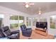 This sunroom features an outdoor view and two black reclining chairs at 2981 Deep Cove Nw Dr, Concord, NC 28027