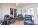 A cozy sunroom with three black reclining chairs at 2981 Deep Cove Nw Dr, Concord, NC 28027