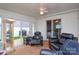 The sunroom includes a glass display case and multiple black reclining chairs at 2981 Deep Cove Nw Dr, Concord, NC 28027