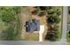 An aerial view of a single-Gathering home featuring a paved driveway and lush surrounding trees at 3500 Manna Ln, Mount Holly, NC 28120