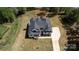 An aerial view of a well manicured two-story house and lawn at 3500 Manna Ln, Mount Holly, NC 28120