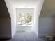 Bright attic features a large window and plush carpet, creating a cozy and inviting space at 3500 Manna Ln, Mount Holly, NC 28120