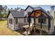 Spacious backyard featuring a covered deck with black railing and stairs to ground at 3500 Manna Ln, Mount Holly, NC 28120