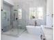 Luxurious bathroom featuring a glass-enclosed shower, freestanding tub, and elegant gold fixtures with marble accents at 3500 Manna Ln, Mount Holly, NC 28120