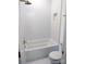 Modern bathroom with hexagonal tile, stylish tub with shower, and golden fixtures at 3500 Manna Ln, Mount Holly, NC 28120