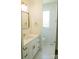Modern bathroom featuring a white vanity with quartz countertop, stylish fixtures and a framed mirror at 3500 Manna Ln, Mount Holly, NC 28120