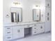 Upscale bathroom featuring double vanity with marble countertop, stylish mirrors, and sleek gold hardware at 3500 Manna Ln, Mount Holly, NC 28120