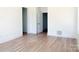 Large bedroom featuring light hardwood floors and neutral walls, creating a serene and versatile space at 3500 Manna Ln, Mount Holly, NC 28120