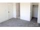 Cozy bedroom featuring soft carpeting and access to multiple rooms for seamless living at 3500 Manna Ln, Mount Holly, NC 28120