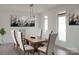 Open dining room with decorative art and many windows provides an airy feel and is perfect for entertaining at 3500 Manna Ln, Mount Holly, NC 28120