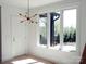 The entryway features a white door and striking chandelier, complemented by bright natural light at 3500 Manna Ln, Mount Holly, NC 28120