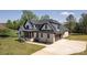 Beautiful two-story home with light brick, black trim, a two car garage and a manicured lawn at 3500 Manna Ln, Mount Holly, NC 28120