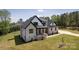 Beautiful two-story home with light brick, black trim, and a manicured lawn at 3500 Manna Ln, Mount Holly, NC 28120