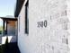 Close-up of the exterior white brick wall featuring black house numbers at 3500 Manna Ln, Mount Holly, NC 28120