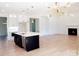 The kitchen features a black island with white countertop, an open floorplan and stainless appliances at 3500 Manna Ln, Mount Holly, NC 28120