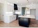 A kitchen offering white cabinetry, a black island, and modern appliances providing a sleek look at 3500 Manna Ln, Mount Holly, NC 28120