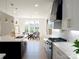 Eat-in kitchen featuring a central island, white cabinetry, and a breakfast nook with backyard view at 3500 Manna Ln, Mount Holly, NC 28120