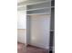 Spacious walk-in closet featuring custom shelving and gold rods maximizing storage in a minimalist design at 3500 Manna Ln, Mount Holly, NC 28120