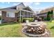 Backyard with fire pit and outdoor seating, plus view of screened in porch at 4715 Amberside Dr, Rock Hill, SC 29732