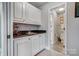Wet bar area with white cabinets and elegant sink, adjacent to a modern bathroom at 4715 Amberside Dr, Rock Hill, SC 29732