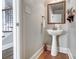Stylish powder room featuring a pedestal sink, wood floors and decorative mirror at 4715 Amberside Dr, Rock Hill, SC 29732
