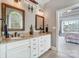 Bathroom featuring a double vanity, granite counters, custom cabinets, and natural light at 4715 Amberside Dr, Rock Hill, SC 29732