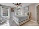 Light-filled bedroom with ceiling fan, patterned bedding, and ample windows at 4715 Amberside Dr, Rock Hill, SC 29732