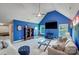 Large bonus room featuring bright blue walls, ample seating, and a ceiling fan at 4715 Amberside Dr, Rock Hill, SC 29732