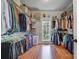 Spacious walk-in closet with custom shelving and hardwood floors at 4715 Amberside Dr, Rock Hill, SC 29732
