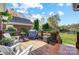 Inviting outdoor deck with wood flooring, grill, seating and views of a beautiful lawn and pond at 4715 Amberside Dr, Rock Hill, SC 29732
