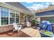 View of a brick home's outdoor deck with seating, potted plants, and grill at 4715 Amberside Dr, Rock Hill, SC 29732