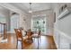 Bright dining room with hardwood floors, elegant light fixture, and traditional wainscoting at 4715 Amberside Dr, Rock Hill, SC 29732