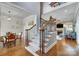 Bright open foyer with hardwood floors, a staircase with iron railings, and views into the dining and living areas at 4715 Amberside Dr, Rock Hill, SC 29732