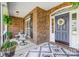 Charming porch with brick accents, outdoor seating, and a stylish rug creating a cozy outdoor space at 4715 Amberside Dr, Rock Hill, SC 29732