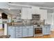 Modern kitchen features stainless steel appliances, granite countertops, and stylish cabinetry with hardwood floors throughout at 4715 Amberside Dr, Rock Hill, SC 29732