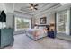 Spacious primary bedroom with tray ceiling, large windows, and elegant decor at 4715 Amberside Dr, Rock Hill, SC 29732