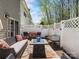 Backyard stone patio with seating, a blue-topped table, and a white privacy fence at 475 Delta Dr, Fort Mill, SC 29715