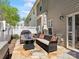 Charming backyard patio with stone pavers, outdoor seating, grill and white privacy fence at 475 Delta Dr, Fort Mill, SC 29715